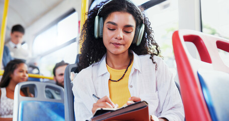 Headphones, notebook and woman on bus for travel with diary for planning, schedule or notes for...