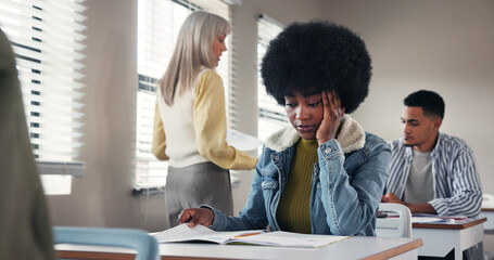 Exam, high school or student in classroom with stress, test or unprepared for assignment. Woman...