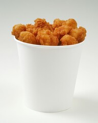 Crispy Chicken Bites Overflowing from a White Paper Bucket on a Seamless Background Studio Shot Food Photography