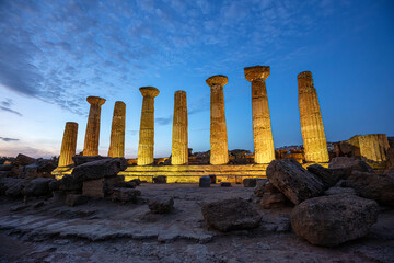 Illuminated temple of heracles standing in the valley of the temples archaeological park at dusk,...