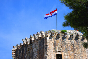 Historical Kamerlengo Fortress in Trogir, Croatia and Croatian flag.