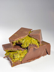 On white background lies Dubai chocolate with pistachio paste and kataifi dough