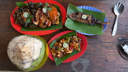 some seafood dishes cooked sweet and sour and whole coconut water to drink