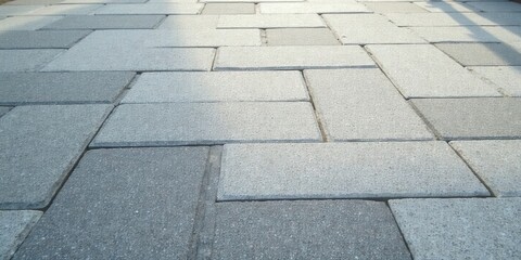 A Serene Perspective of Interlocking Stone Pavement Blocks in a Subtle Gray Hue