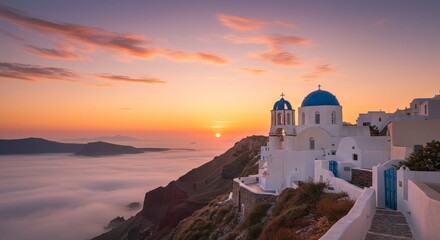 Obraz premium Sunset Over Aegean Sea Church - Picturesque white church with blue domes perched on a cliff overlooking a sea of clouds at sunset. Tranquil and idyllic scene