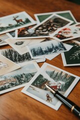 Colorful assortment of postcards scattered on wooden surface, sh