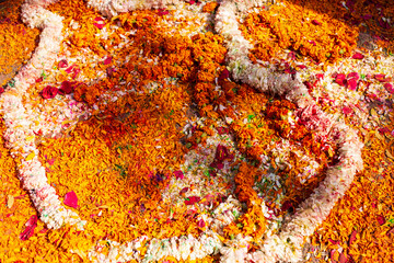 High angle view of colourful yellow, white and orange flower petals seen on the ground for the Holi festival, Jaipur, Rajasthan, India