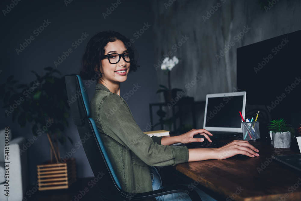 Aufkleber young woman programmer working remotely on computer in a stylish home office with a professional set
