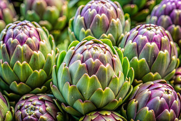 Fototapeta premium Close-up of fresh purple-green artichokes with dew drops. Ideal for organic food, plant-based diet, and farm-to-table concept visuals.