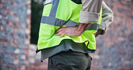 Hands, person and back pain with construction injury, work site accident or strain with agony outdoor. Spine, contractor burnout with muscle tension or pressure, inflammation or fibromyalgia