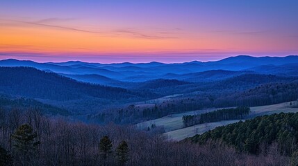 Obraz premium First light of dawn peeking over rolling hills