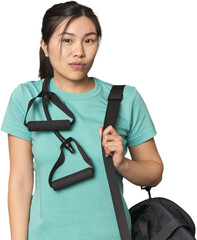 Chinese athlete using resistance bands shrugs shoulders and open eyes confused.