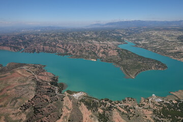 Scenic View of Lake Negrat&iacute;n in Andalusia, Spain &ndash; Turquoise Water and Arid Hills under a Clear Sky