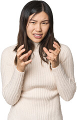 Young Chinese woman upset screaming with tense hands.