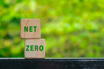 net zero words text on wooden blocks isolated on green nature background. carbon neutral net zero emissions concept
