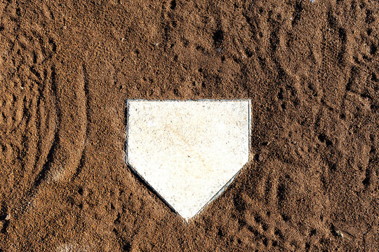 home plate from above, cleat marked clay soil around plate