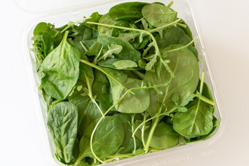 Spinach and Arugula in a Plastic Container