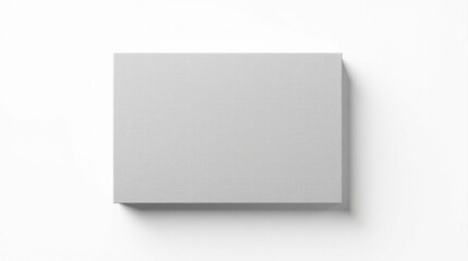 Fototapeta premium A light gray rectangular canvas, perfectly positioned on a pristine white background, offers a minimalist aesthetic for design inspiration