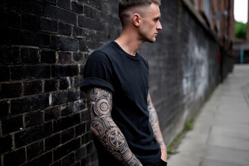 Obraz premium A tattoo model with a detailed, black and grey sleeve tattoo of mechanical gears, posing in a dark alley.