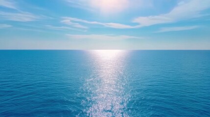 Fototapeta premium Aerial view of blurred calm ocean surface, shimmering with soft sun reflections, gentle waves moving slowly