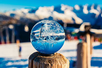 Crystal ball - with a lasered edelweiss inside - alpine landscape shot at Mount Zwieselalm, Gosau,...