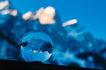 Crystal ball - with a lasered edelweiss inside - alpine landscape shot at Lake Gosausee, Gosau,...