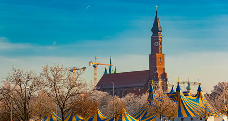 A church and yellow blue circus tents on a sunny winter day at Straubing, Straubing-Bogen, Bavaria,...
