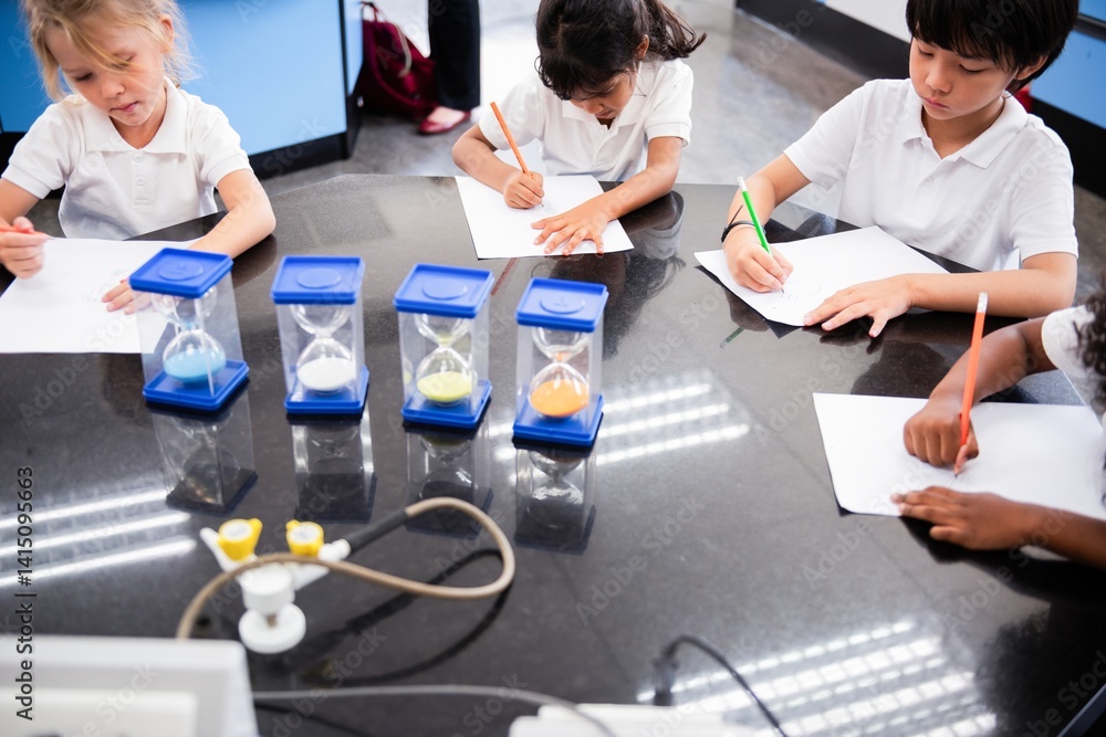 Poster Children student in classroom drawing. Students learning science in classroom. Science classroom with students focusing on drawing and learning from hourglass. Kids learning science. Education concept