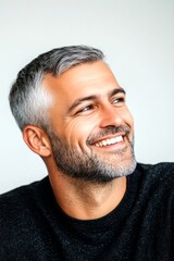 Fototapeta premium Graphic pattern of style for aging men. Pure white solid background. Trendy men's classic short back and sides haircut - midlife white man with grey hair. A happy man in a studio photo.