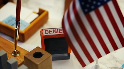 Close-up shot of denied stamp at U.S. embassy office, consular refusal of entry