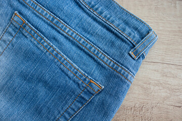 Background denim texture. Close-up of blue denim jeans with visible pocket and stitching detail