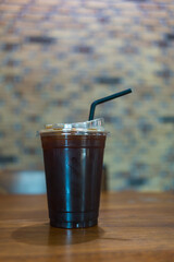 Take out glass of iced americano with straw.