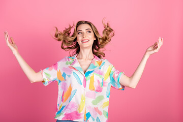 Enthusiastic young woman with trendy casual outfit gesturing with happiness on a pink background,...