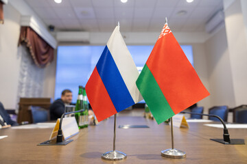 Flags of cooperation between Russia and Belarus. Flags of Russia and Belarus on the negotiating table. Ideal for news.