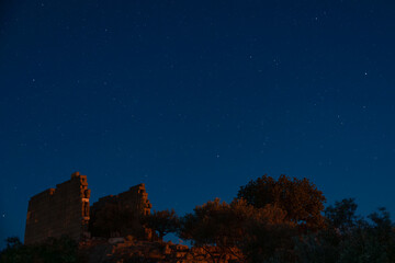 Astrophotography over the ancient ruins of the Temple of Athena near Lake Bafa, Turkey.