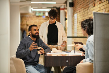 Collaborative discussion among colleagues in a modern office space during a productive work session