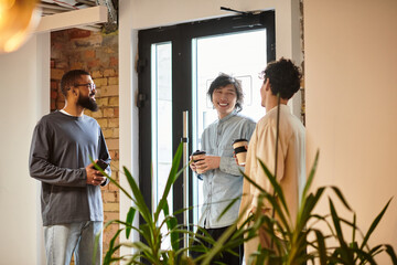 Casual conversations among colleagues in a modern office environment with vibrant greenery