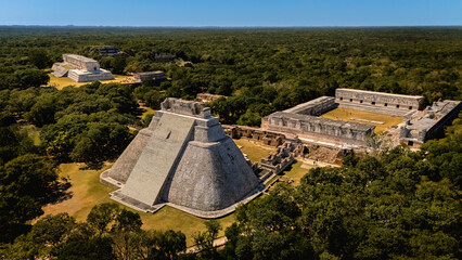 Aerial view of the Mayan archaeological site Uxmal with Magician's Pyramid in the foreground and...