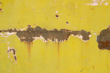 The rusted iron wall surface is the old wall of the train.