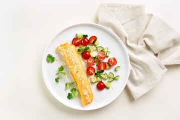 French omelette with cheese served with fresh vegetables
