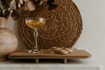Champagne Glass and Cookies on Rustic Wooden Tray with Woven Decor