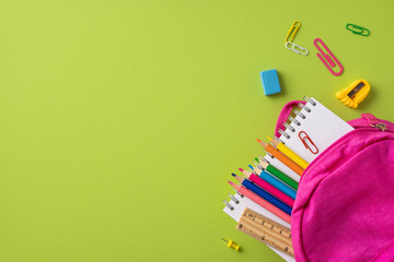 Essential school supplies with a pink backpack on a green background, featuring stationery items...