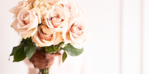 A bouquet of pale pink roses with lush green leaves, elegantly arranged. The roses are fresh, soft, and beautifully displayed, perfect for any occasion. Beautiful bouquet of pink roses.