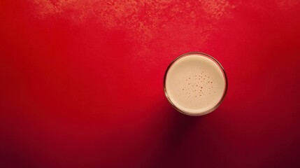 Creamy Frothy Drink in Glass on Red Background: A Minimalist Beverage Photography