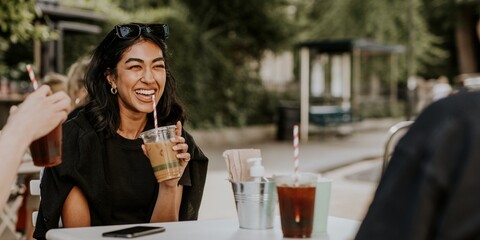 Friends enjoying iced coffee outdoors