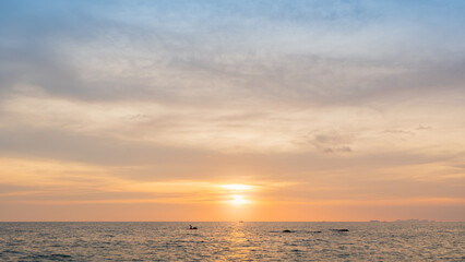Horizon sea sky background, Sunset sky clouds over sea in the evening with orange, yellow sunlight golden hour in summer landscape, Dusk sky seascape backgrounds