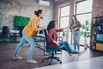 Young professionals engaging in playful and collaborative activity at a modern coworking space.