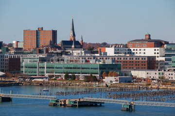 Views from the Atlantic Ocean of buildings among the skyline of Portland, Maine on an autumn morning.