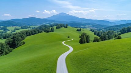 Winding road through lush green hills, a tranquil mountain landscape