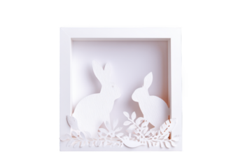 Papercut Paradise: A Delicate Easter Scene with Two Rabbits Amidst Floral Details in a White Shadow Box, Evoking Springtime Joy
